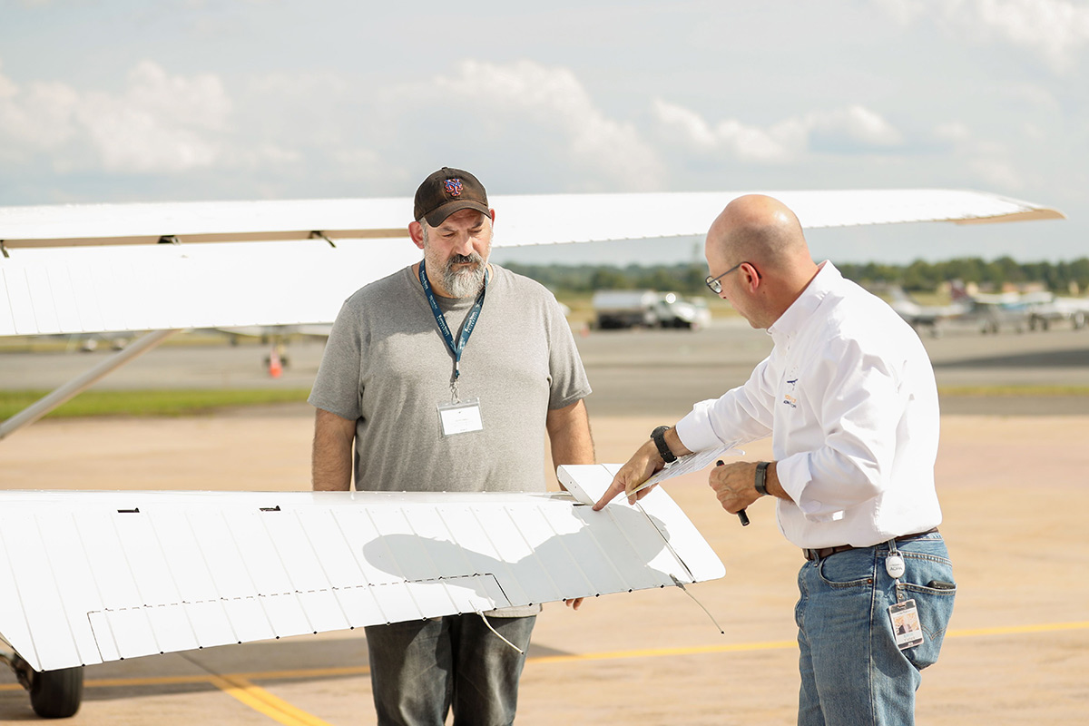 A plane, undergoing an inspection on the ramp.
